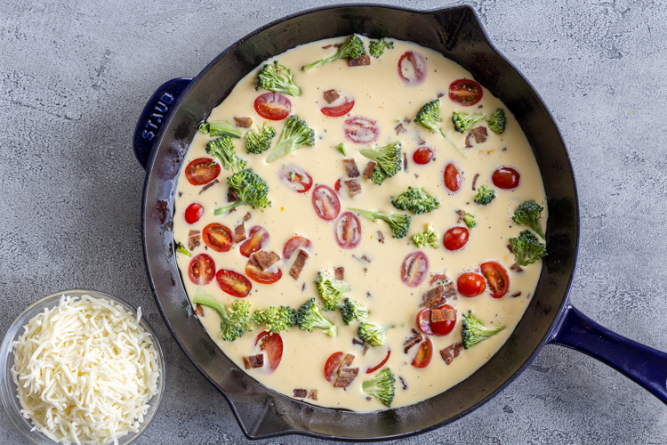 eggs and veggies and cheese in a bowl