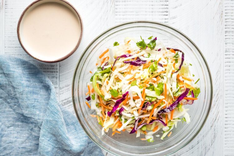 Prep bowls filled with slaw and adobo crema.