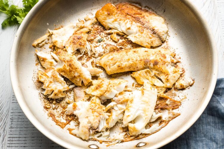 Pan-fried fish, seasoned and broken apart for tacos.