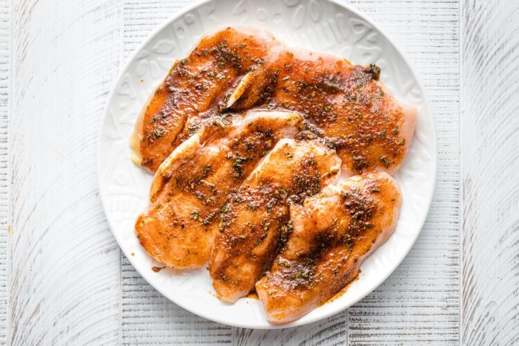 Chicken with jerk seasoning, ready to grill.