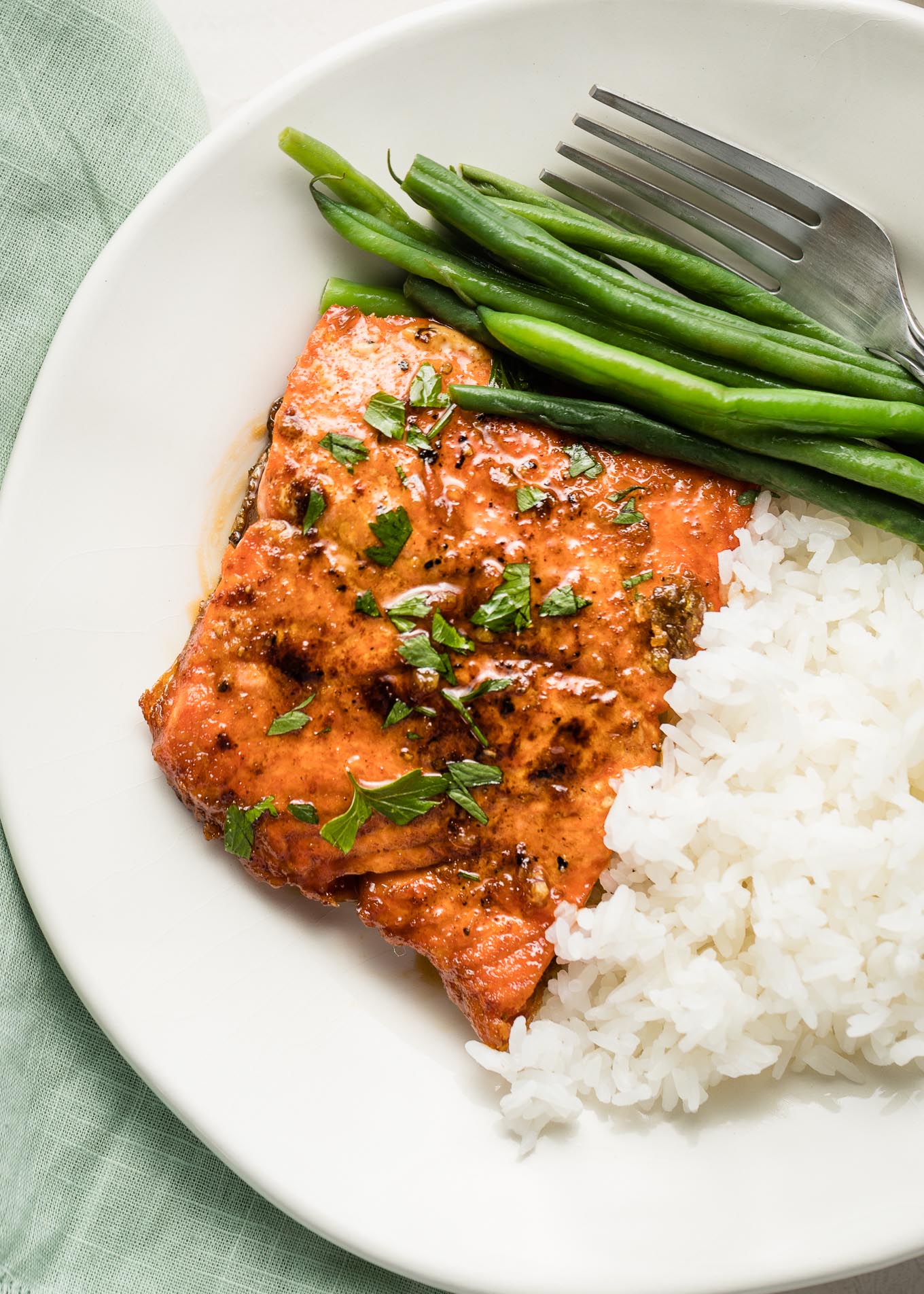 Honey garlic salmon plated with rice and green beans.