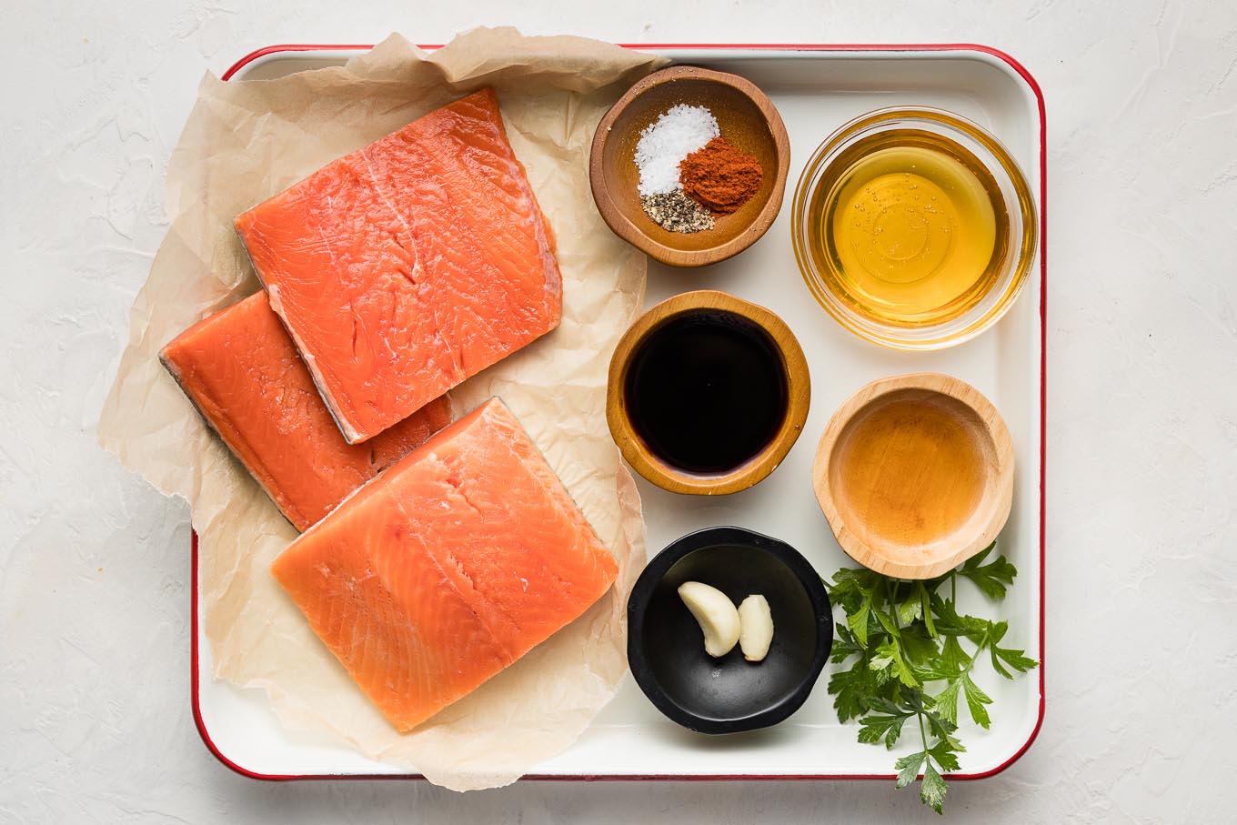 Salmon filets, seasonings, soy sauce, honey, apple cider vinegar, and parsley.