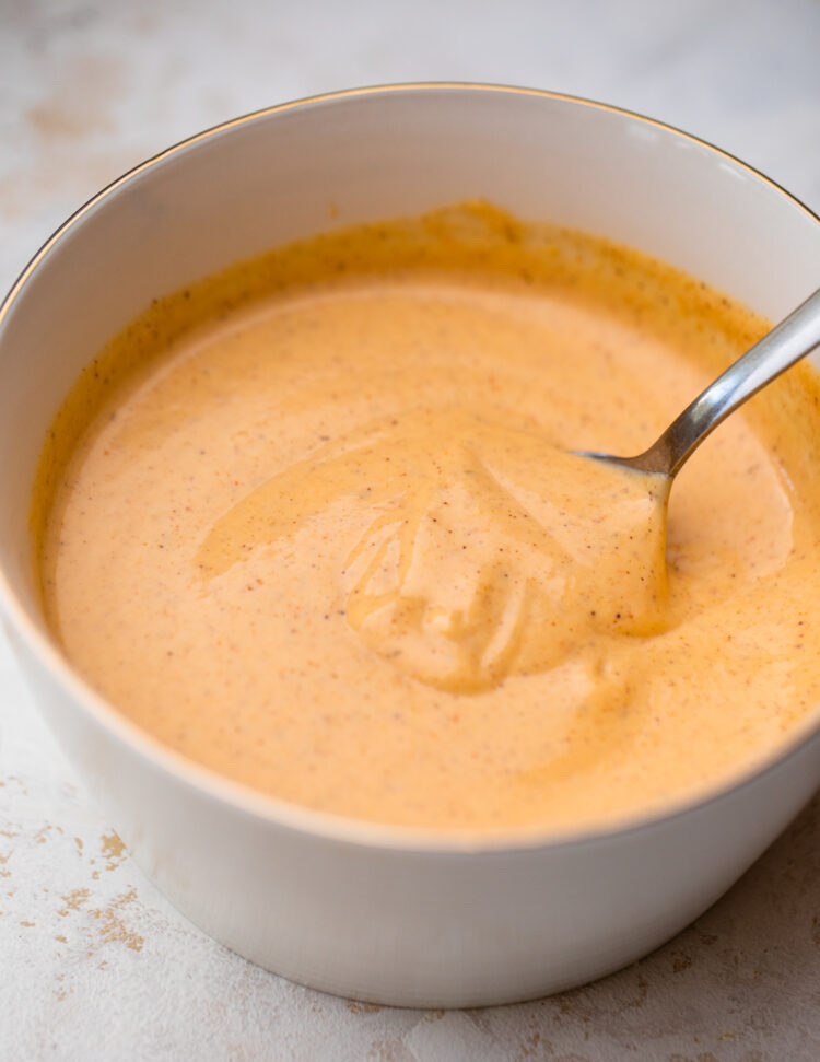spoon dipping into the bowl of yum yum sauce