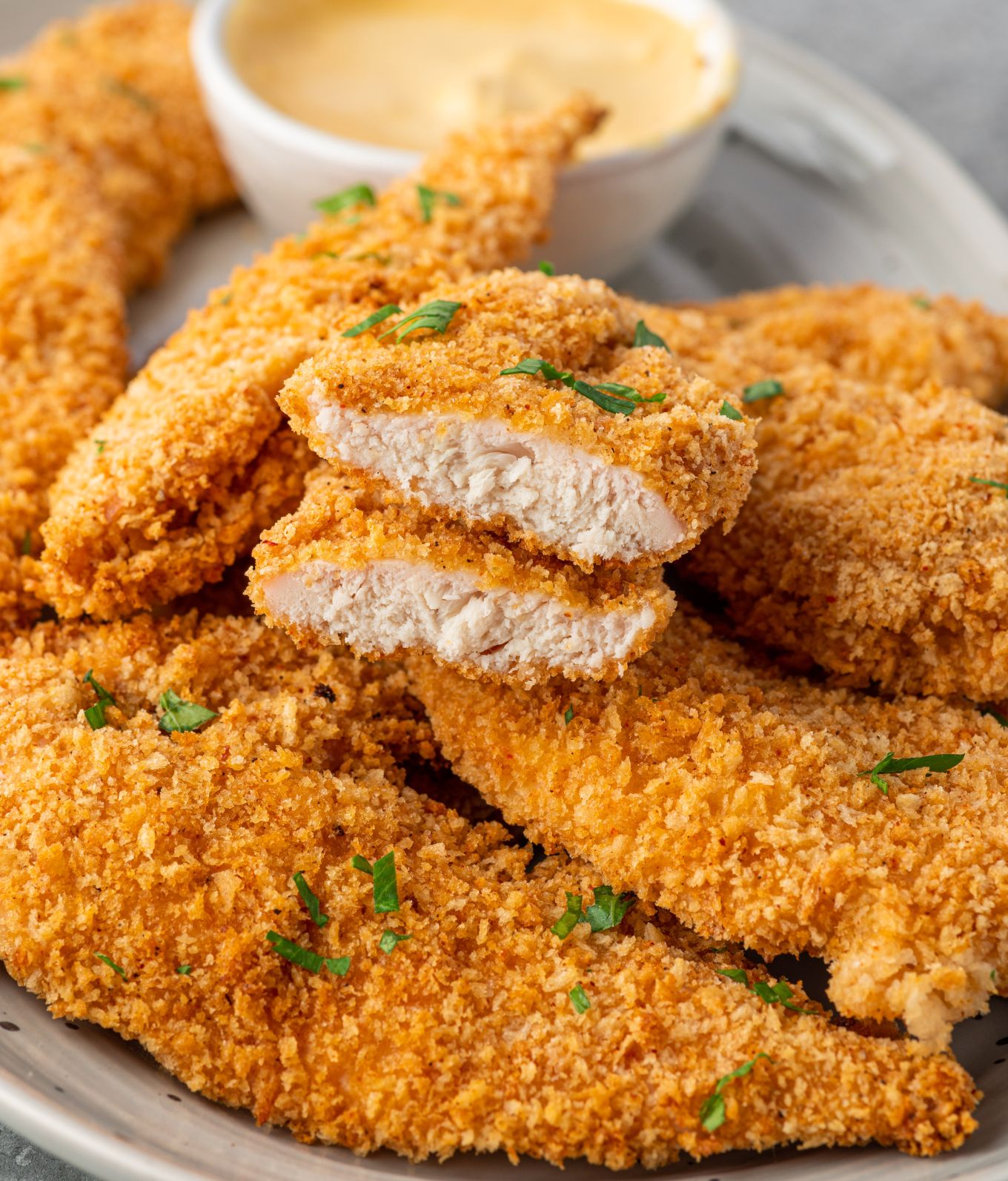 Chicken tenders with one cut in half.