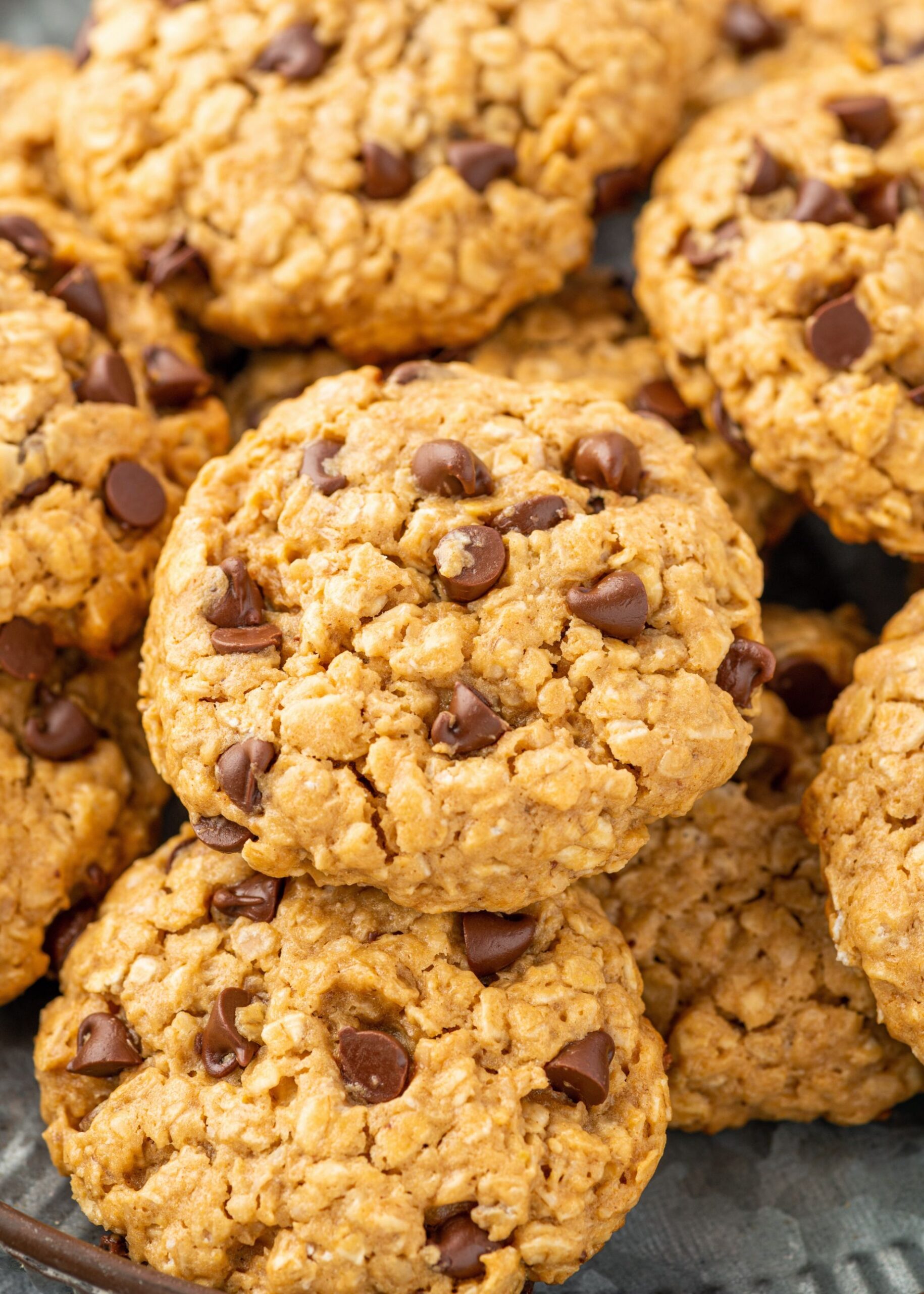 Chocolate chip cookies stacked on top of one another.