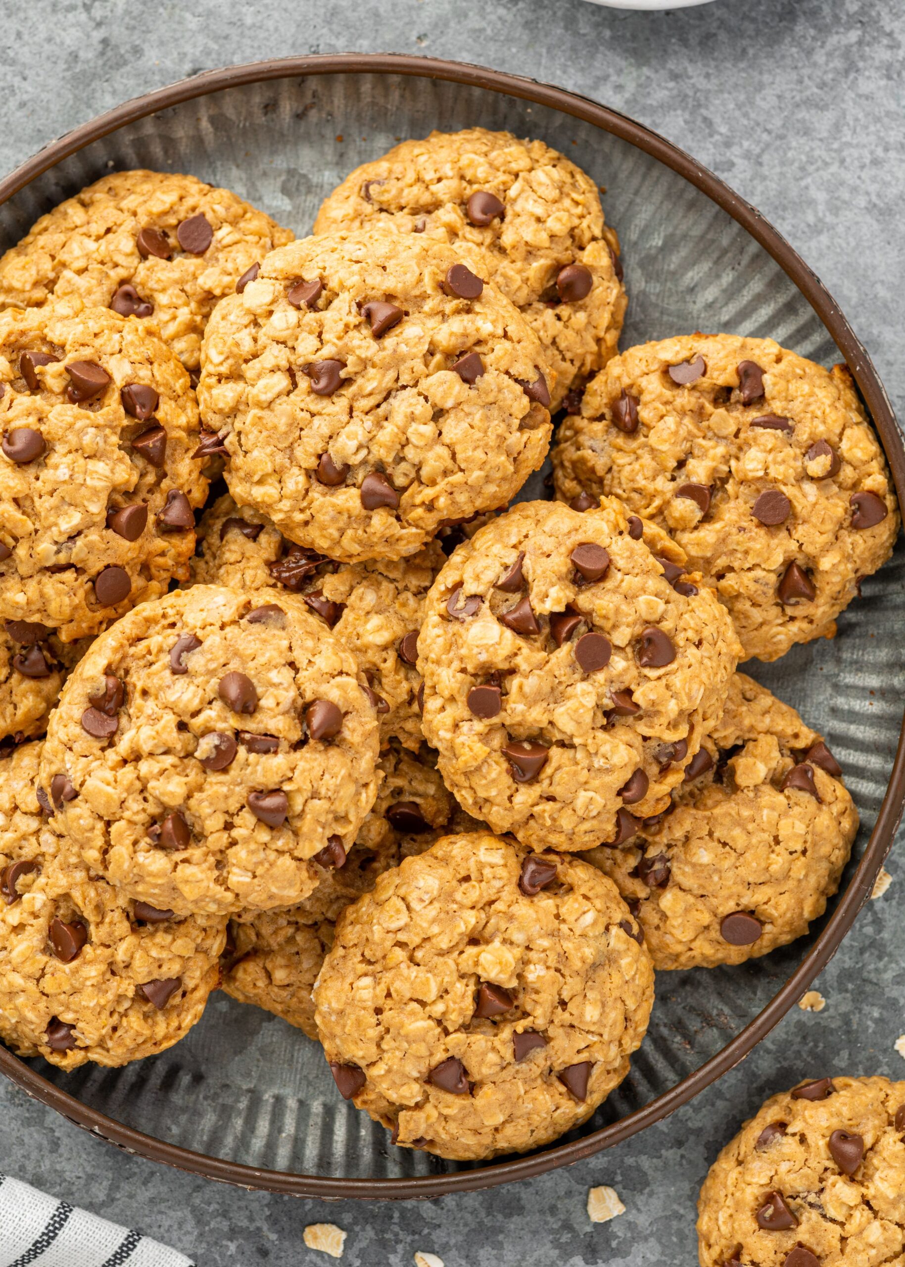 Chocolate chip cookies stacked on a plate.