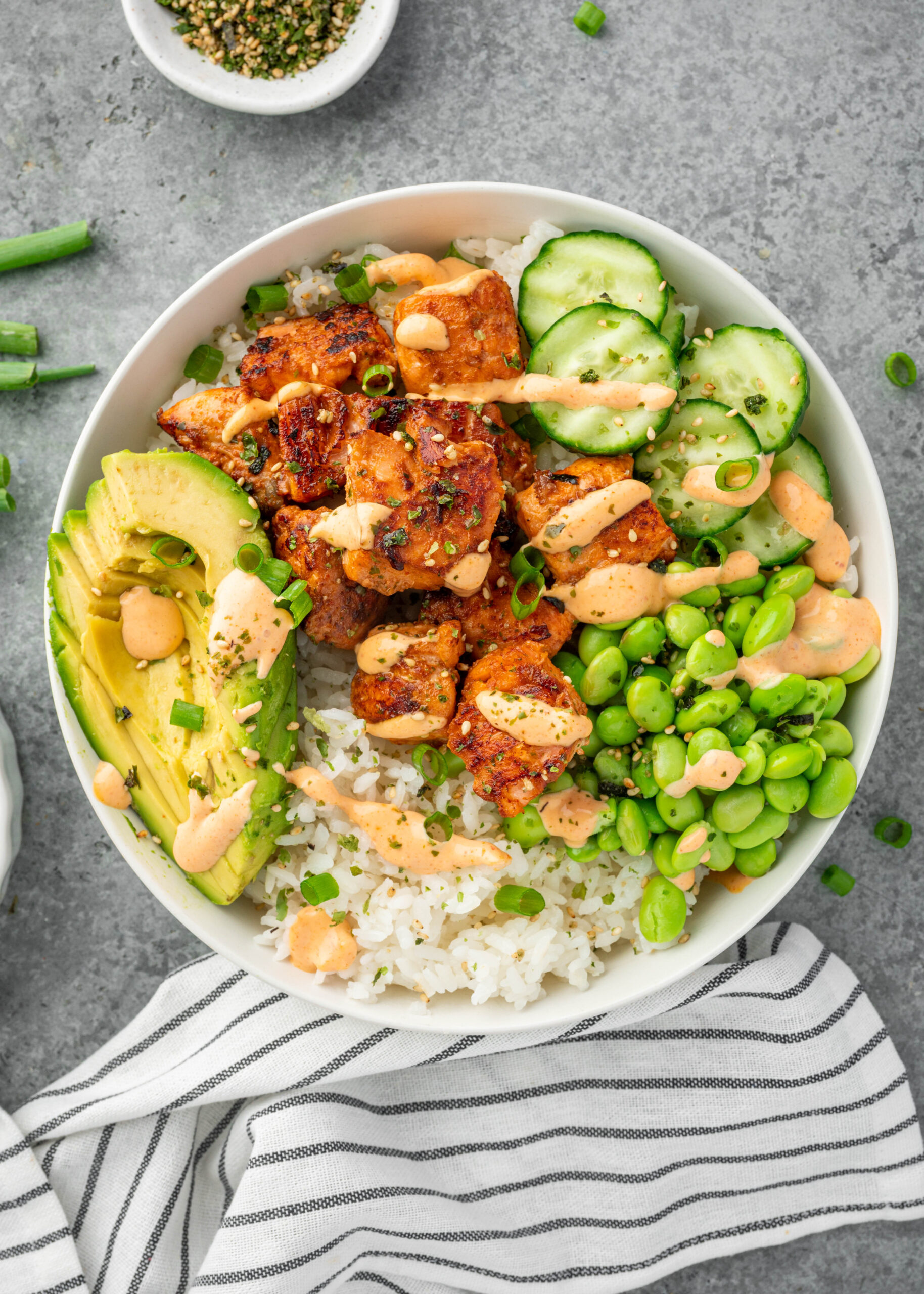 Salmon Maki Bowl served with edamame, cucumber, avocado and rice.