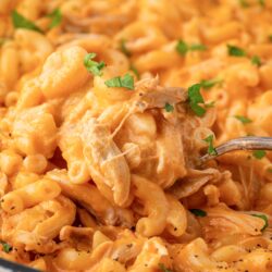 Spoon dishing out buffalo chicken Mac and cheese.