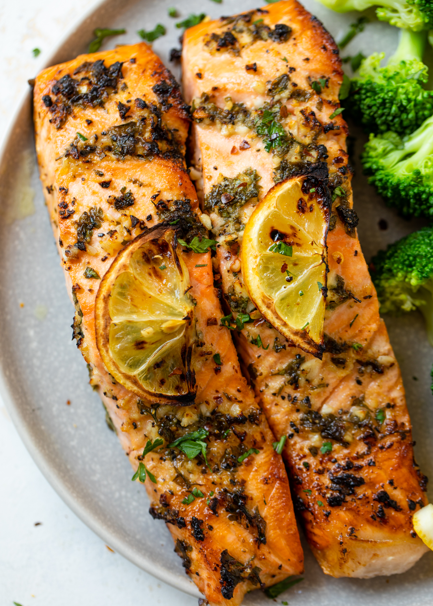 Two filets of salmon on a plate.