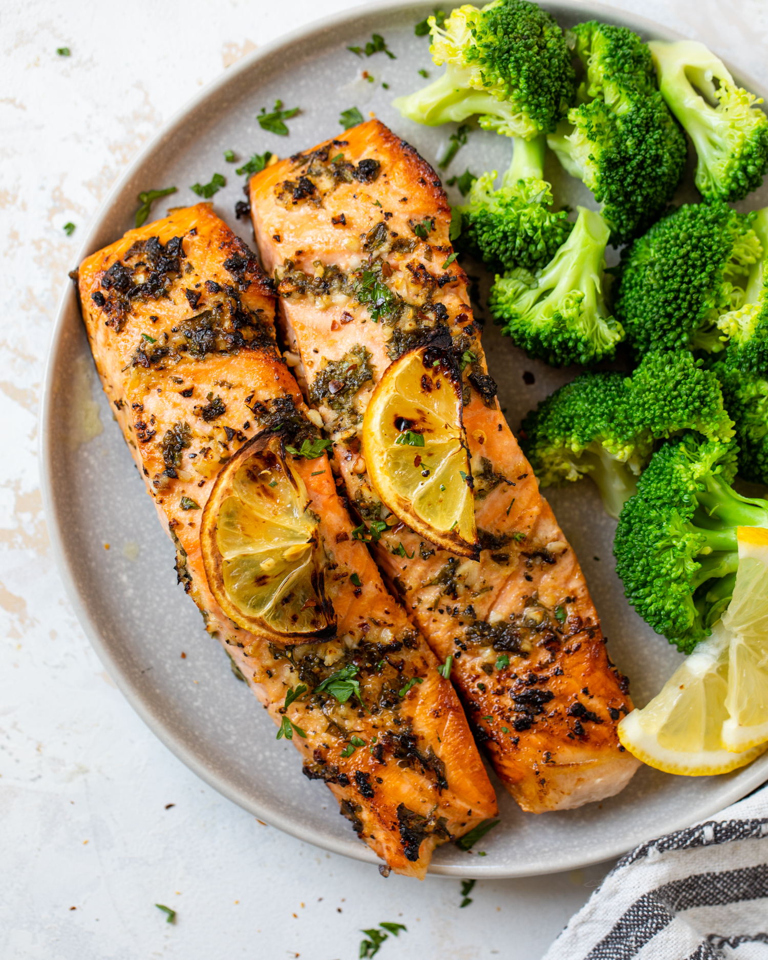 Lemon garlic salmon plated with steamed broccoli.