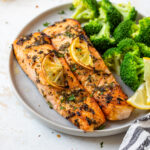 Lemon garlic salmon served with steamed broccoli.