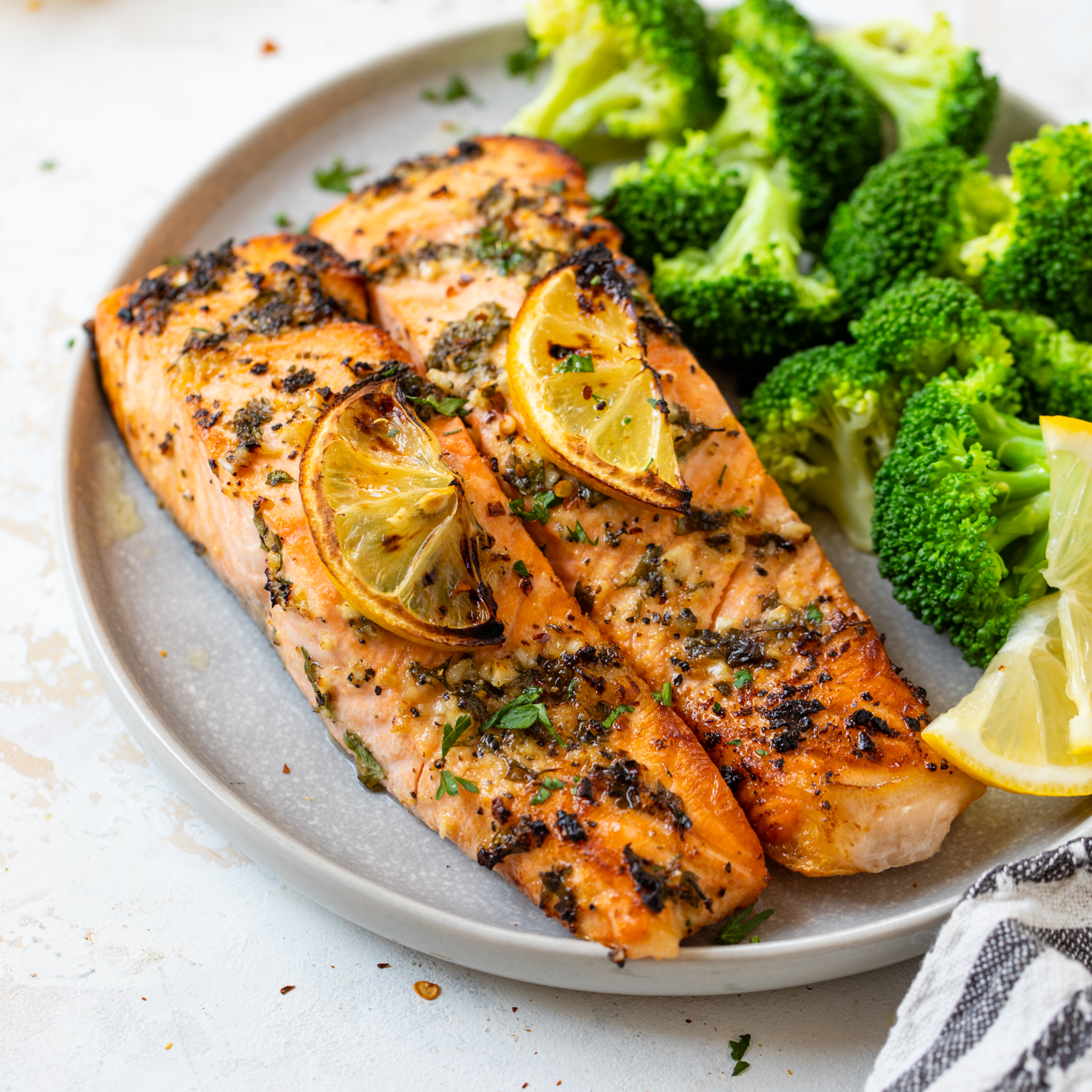 Lemon garlic salmon served with steamed broccoli.