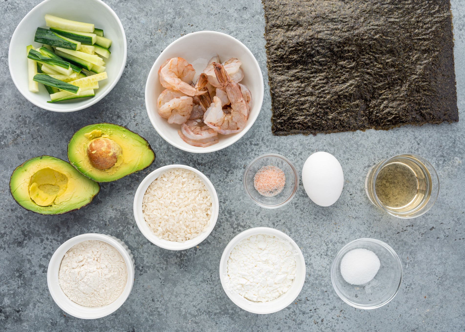 Ingredients to make sushi rolls divided into portions.