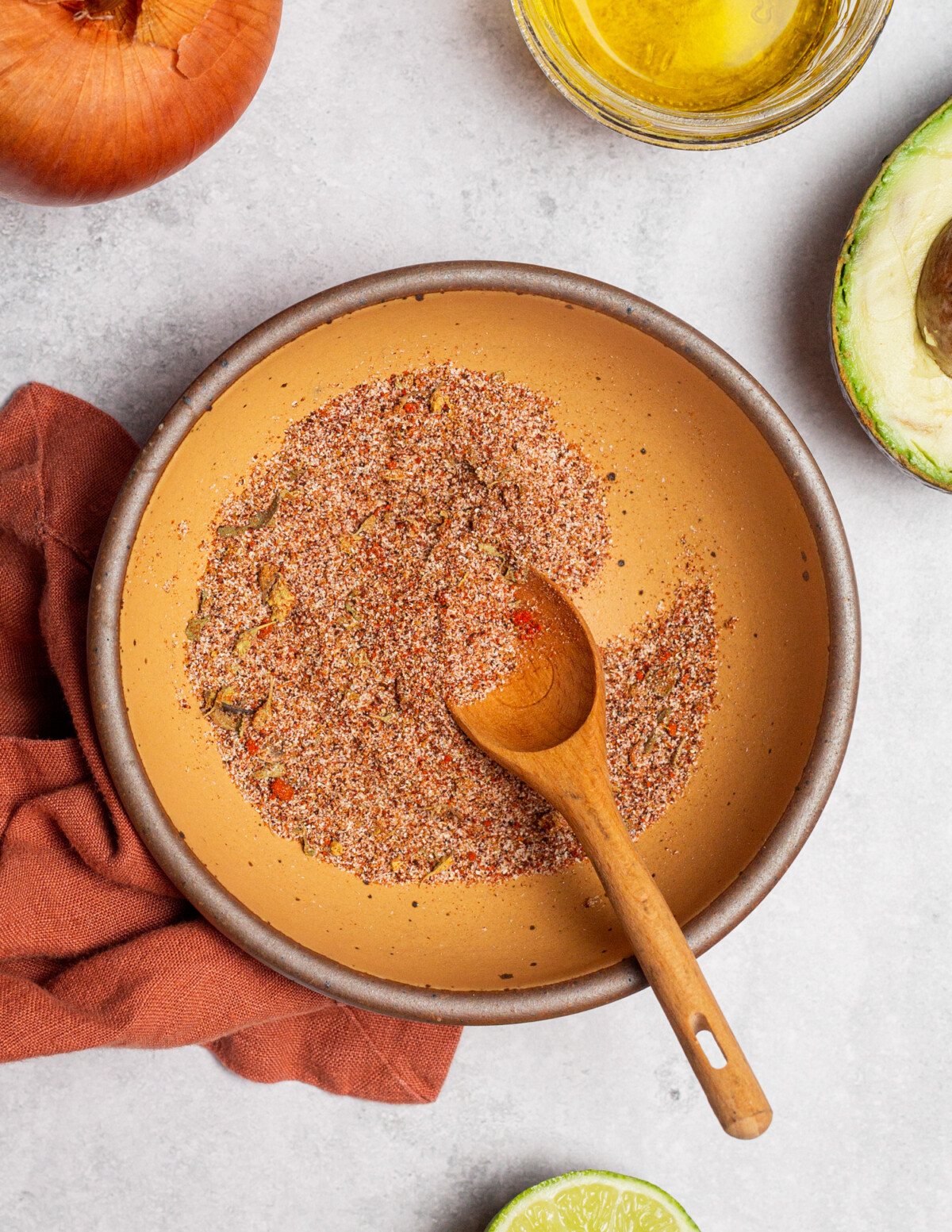 Stirring together fajita seasoning in a small bowl.